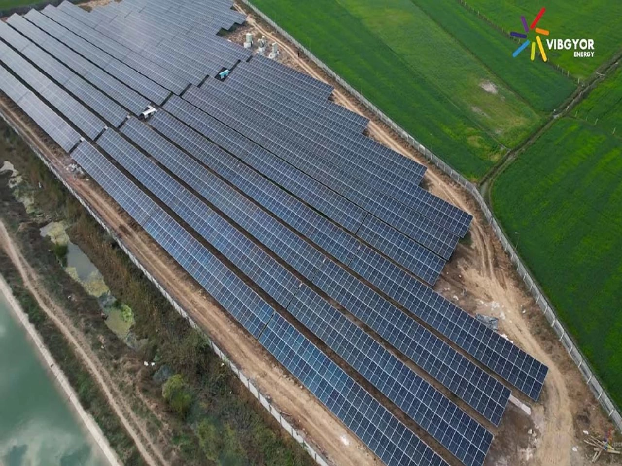 Aerial view of ground-mount solar rows running across open land at Kota, Rajasthan