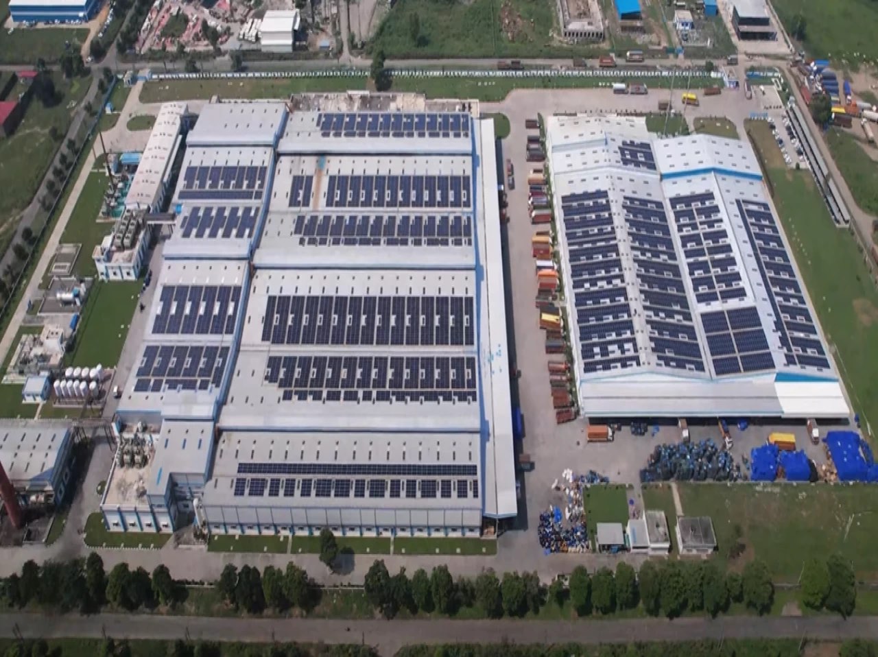 Aerial view of solar arrays across multiple production halls at Pathankot, Punjab