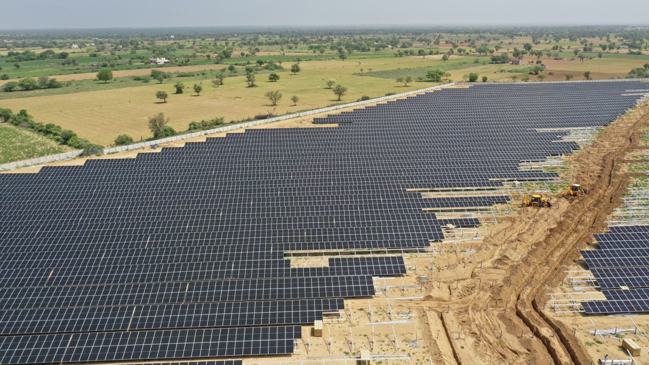 Aerial view of the 22.5 MWp solar plant under construction at Chamu, Rajasthan, the array sweeping towards farmland on the horizon