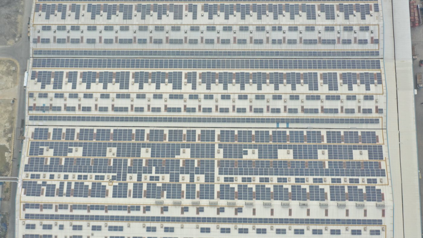 Rooftop solar array across an industrial production hall